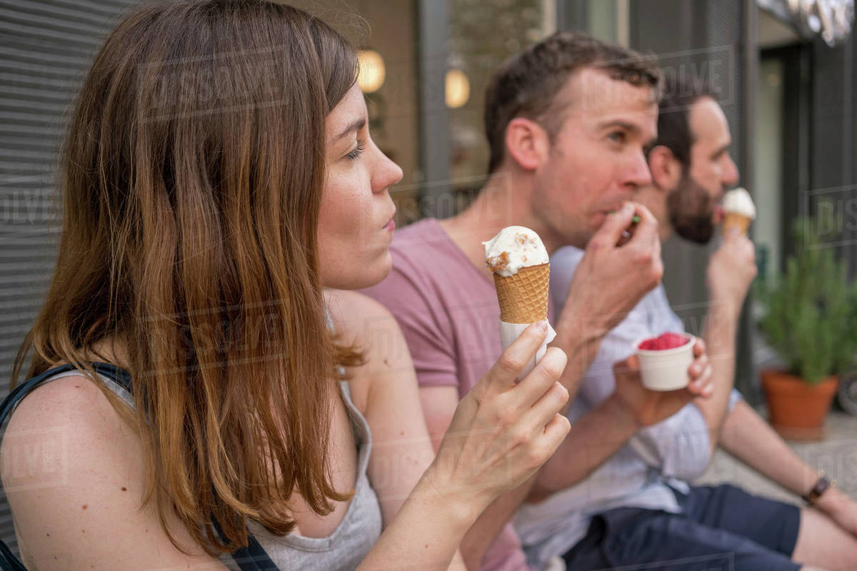 Group of entrepreneurs having ice cream break Stock Photo Dissolve