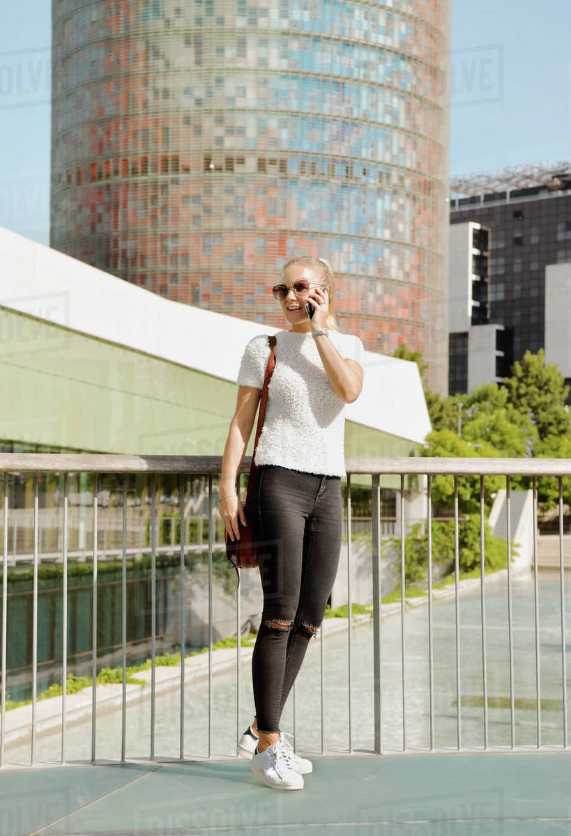 Woman using smartphone in city, Barcelona, Catalonia, Spain Royalty-free stock photo