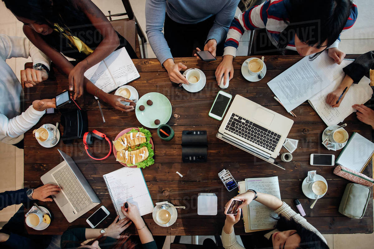 Female and male business team meeting at cafe table, overhead view Royalty-free stock photo