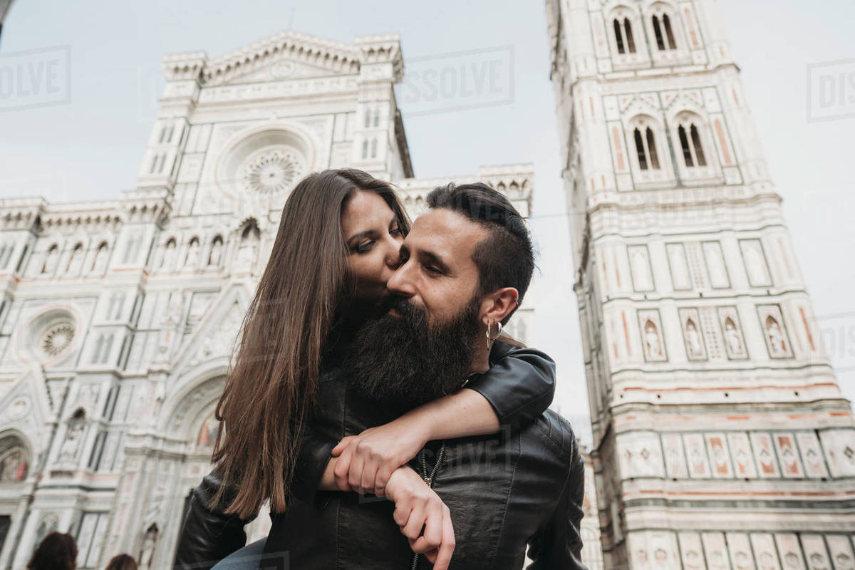 Couple playing piggyback ride and kissing, Santa Maria del Fiore, Firenze, Toscana, Italy Royalty-free stock photo