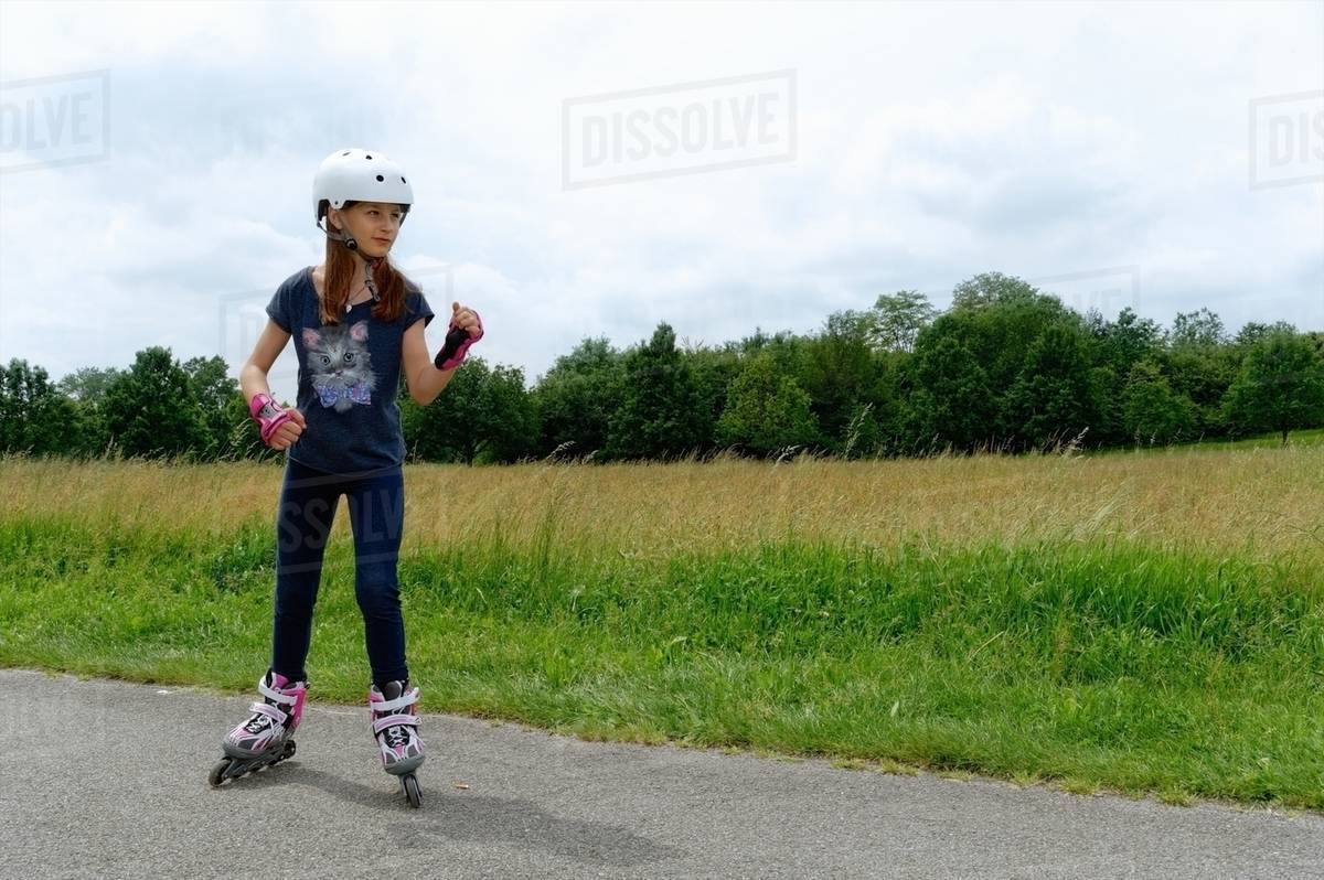 Girl rollerblading in park Stock Photo Dissolve
