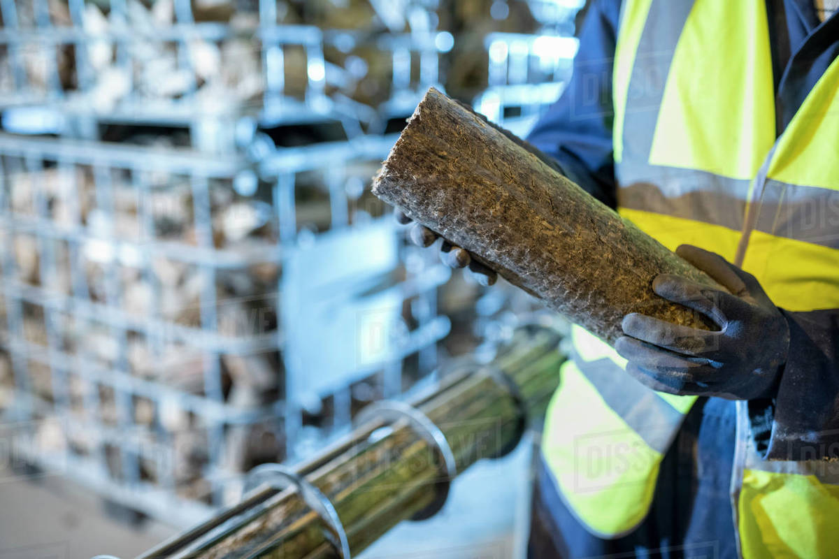 Worker with recycled wood in wood recycling plant. - Stock Photo - Dissolve