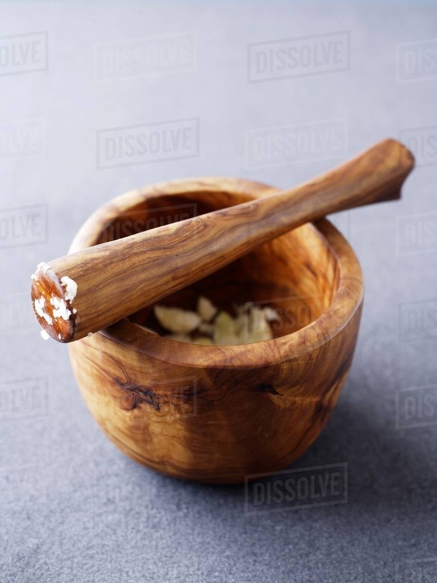 Wooden Pestle And Mortar With Crushed Garlic Stock Photo Dissolve Wooden Pestle And Mortar With Crushed Garlic