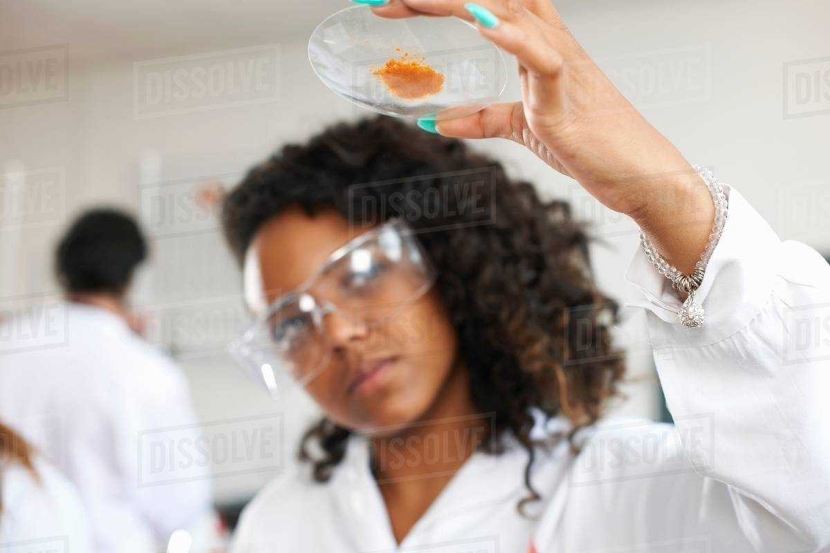Chemistry student holding chemical - Royalty-free Stock Photo | Dissolve