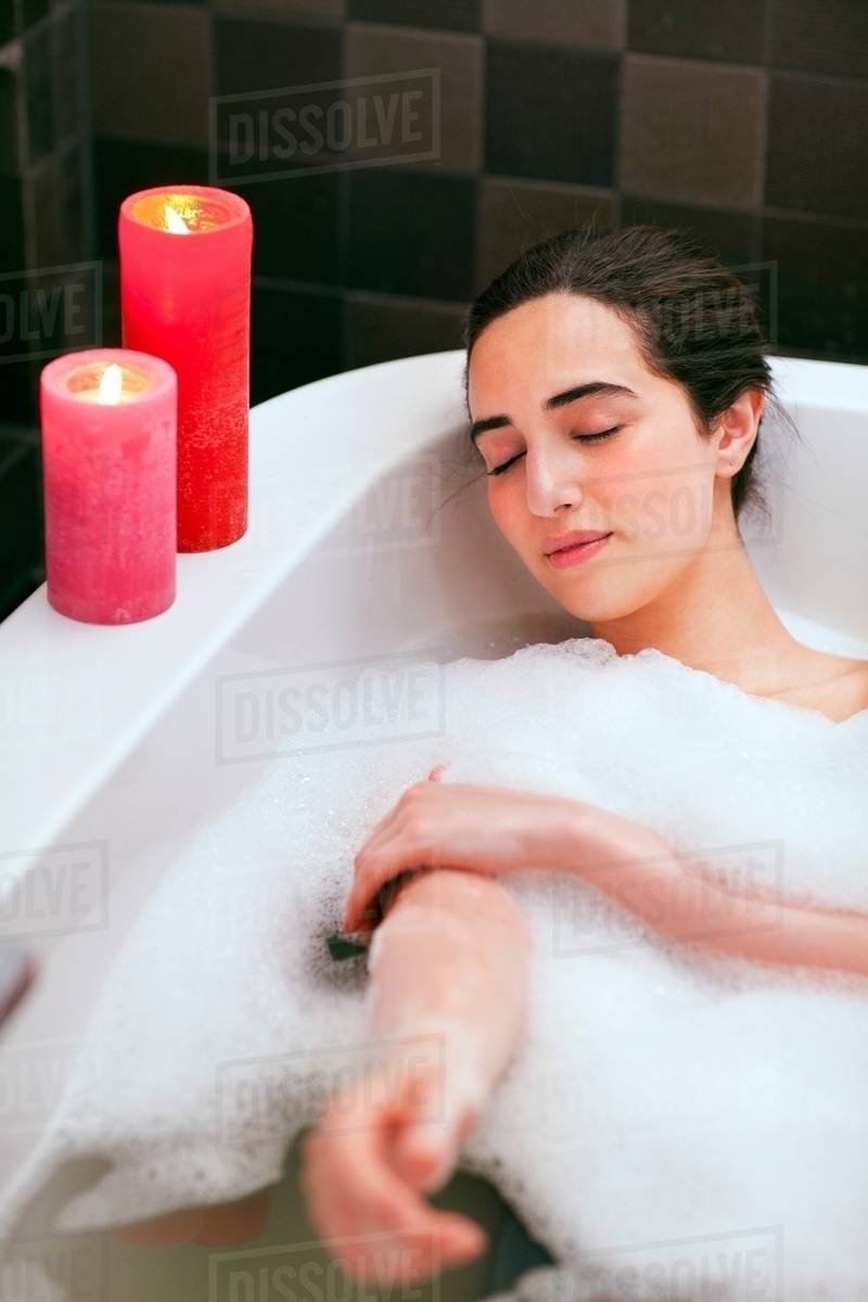 Young woman relaxing in bubble bath Stock Photo Dissolve