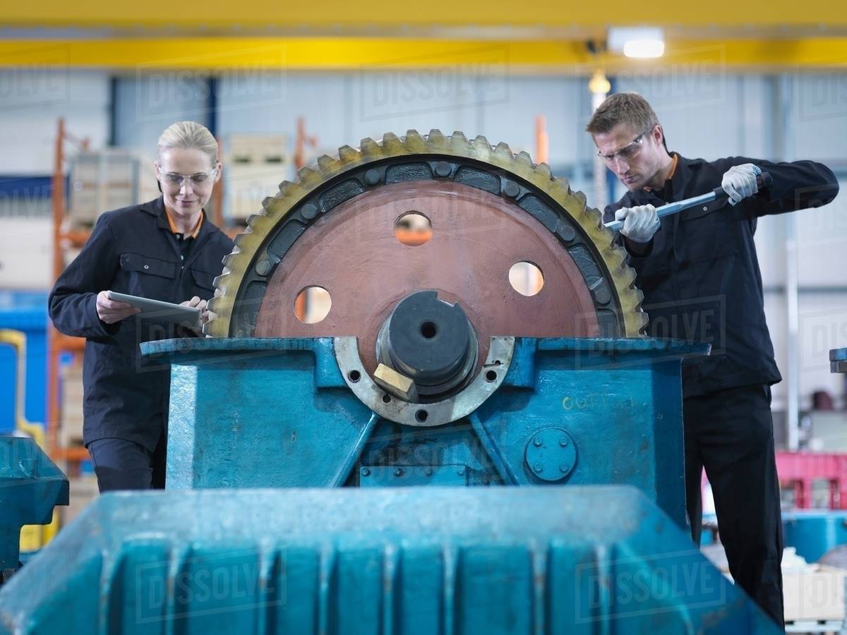 Engineers repair industrial gearbox in engineering factory Stock