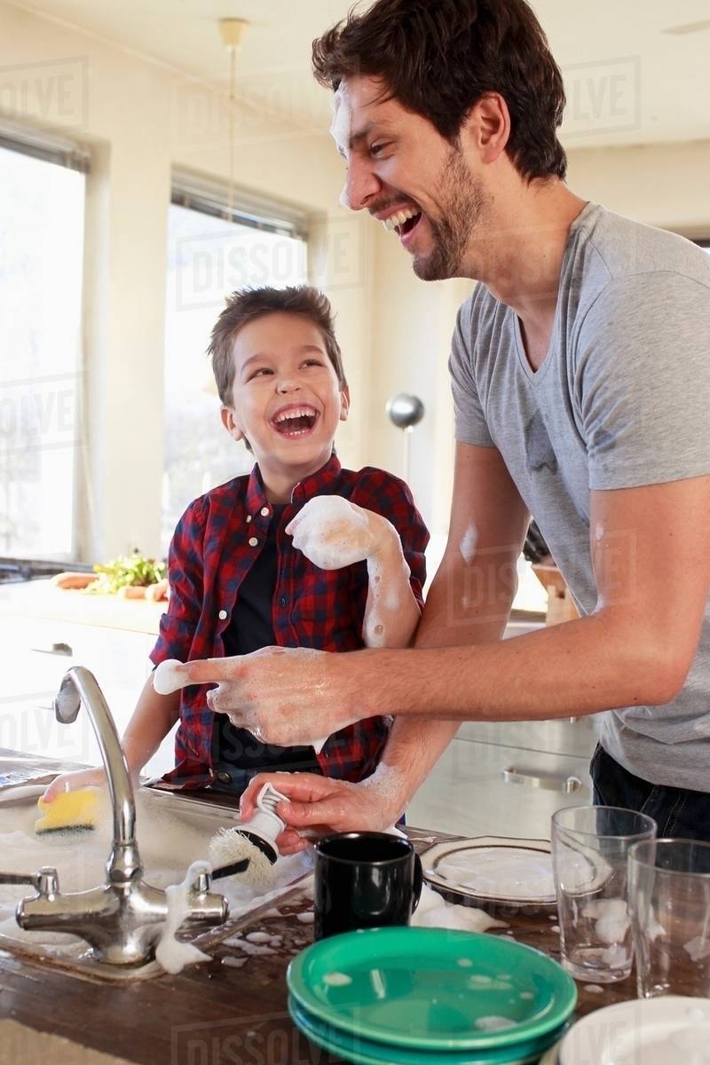 Father and son with soap suds on hands Stock Photo Dissolve