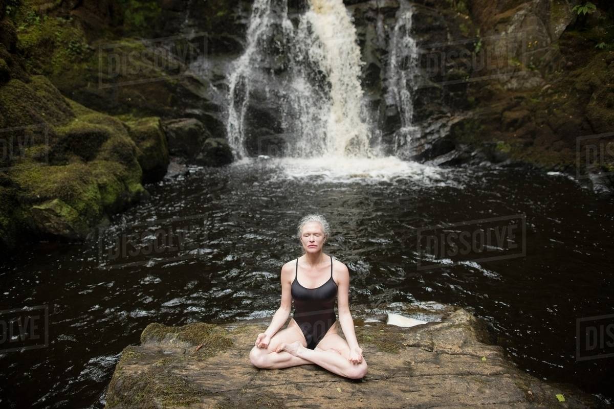 Mature woman practicing lotus pose in
