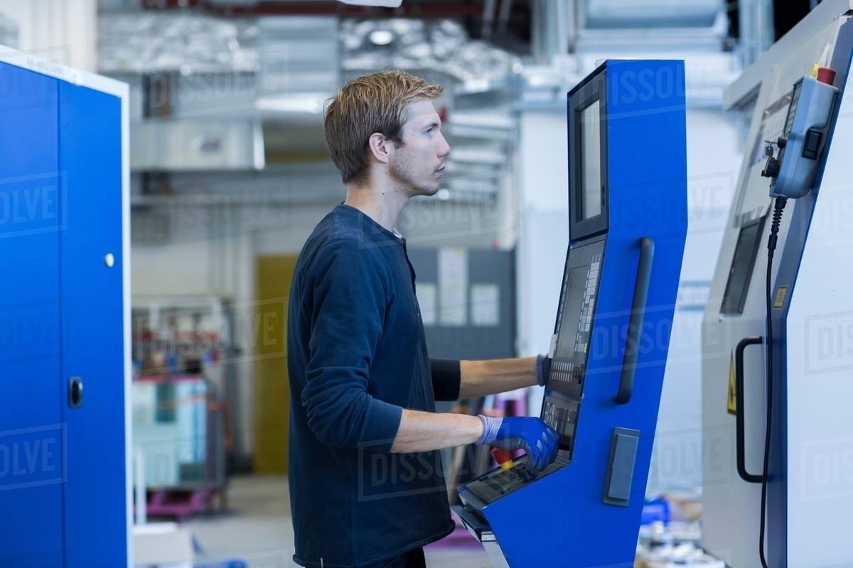 Factory technician working on control panel Stock Photo Dissolve