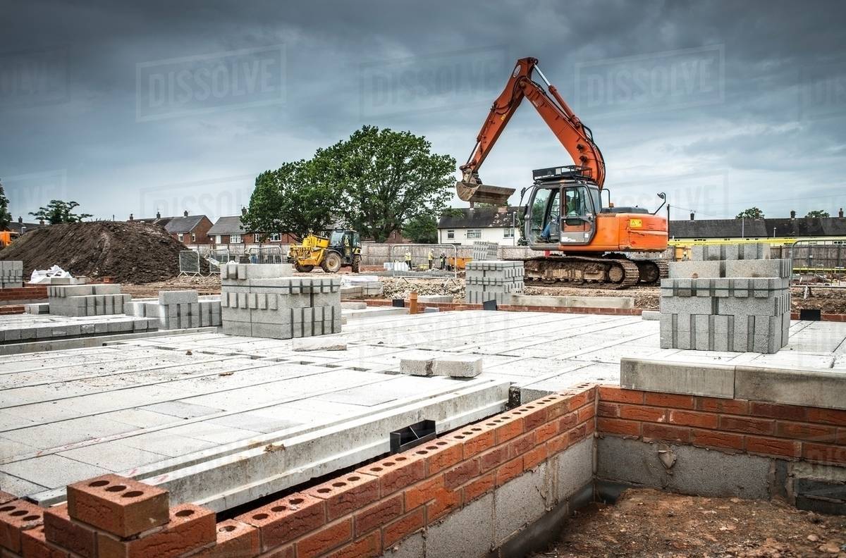 Tractor, building materials on construction site Stock Photo Dissolve