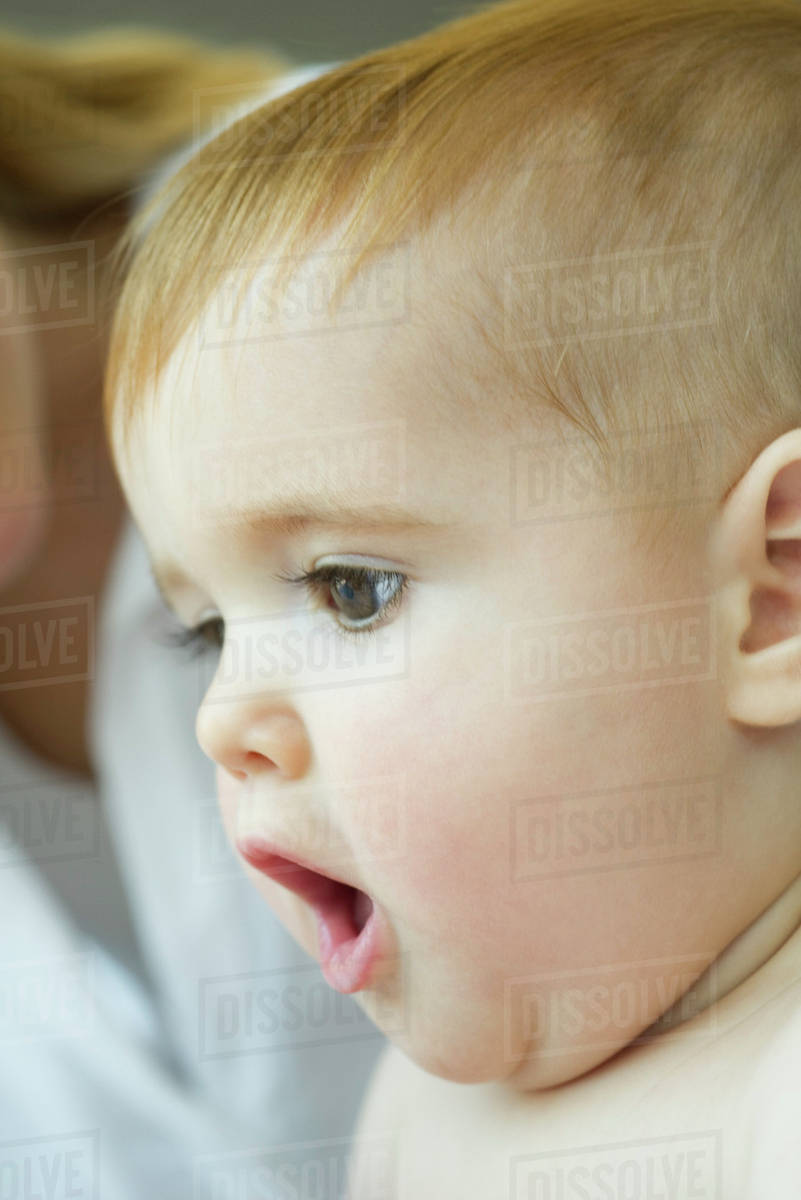 Baby with mouth open in surprise Stock Photo Dissolve