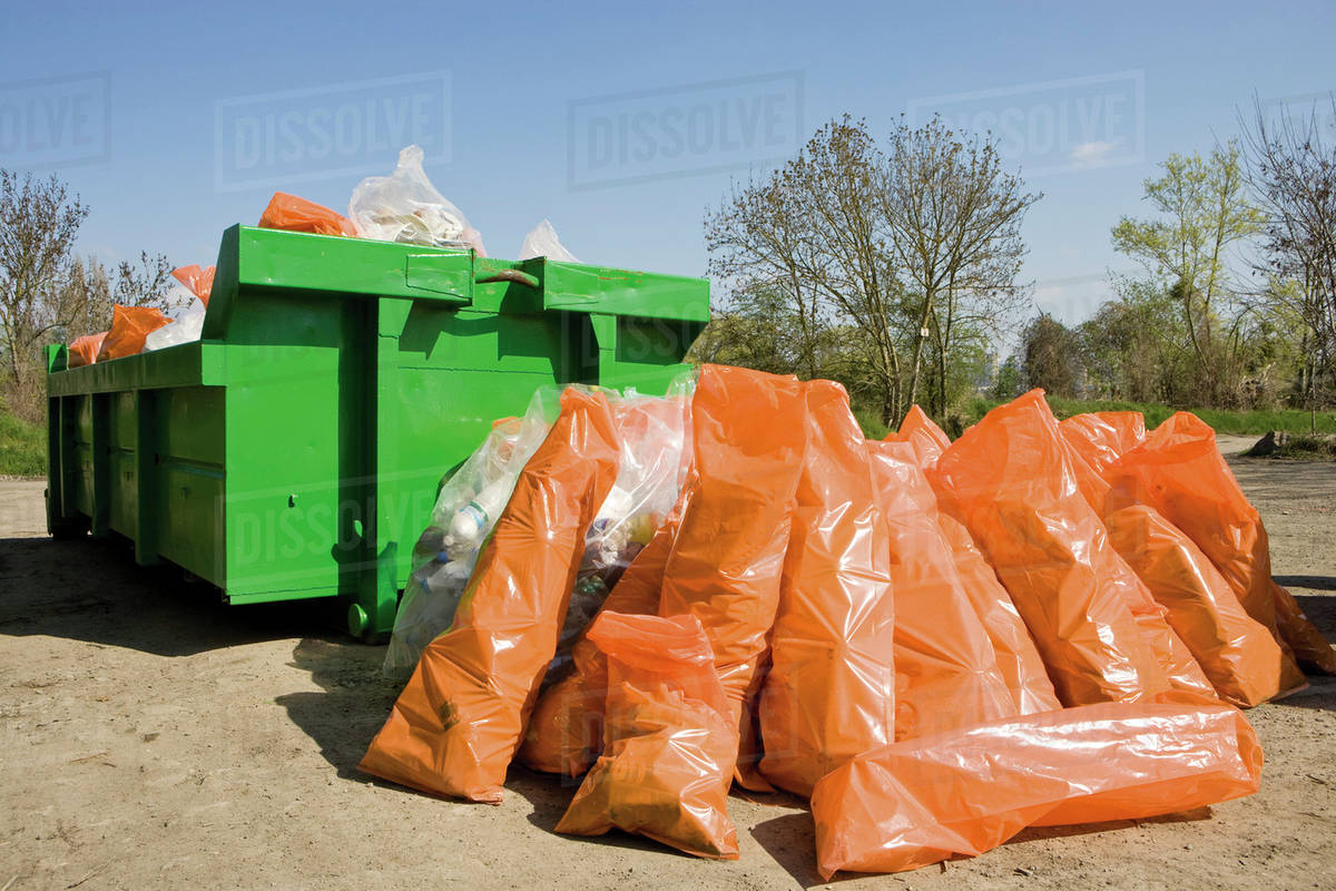 Garbage Bags Piled Beside Dumpster Stock Photo
