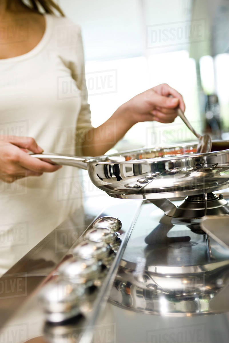 Cooking on gas stove Stock Photo Dissolve