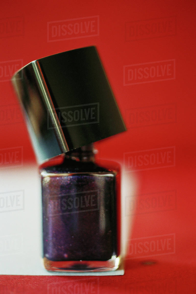 Nail polish bottle, opened, closeup Stock Photo Dissolve