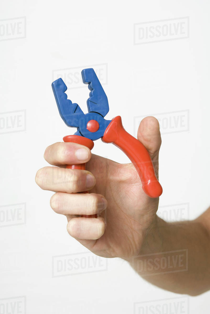 Hand gripping pliers, closeup Stock Photo Dissolve