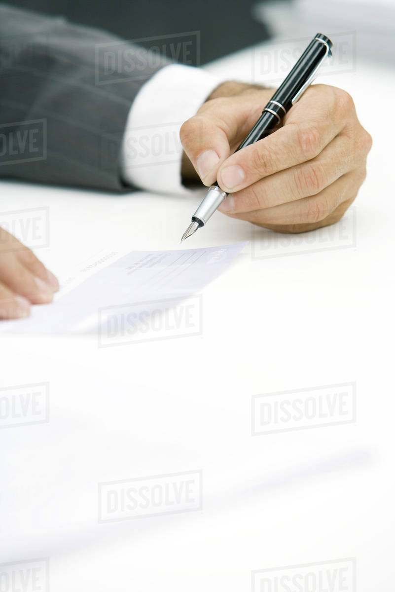 businessman signing check cropped view of hand d984_28_803 signing a check