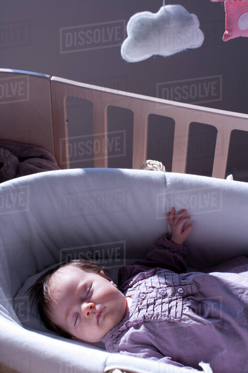 Baby sleeping in crib Stock Photo Dissolve