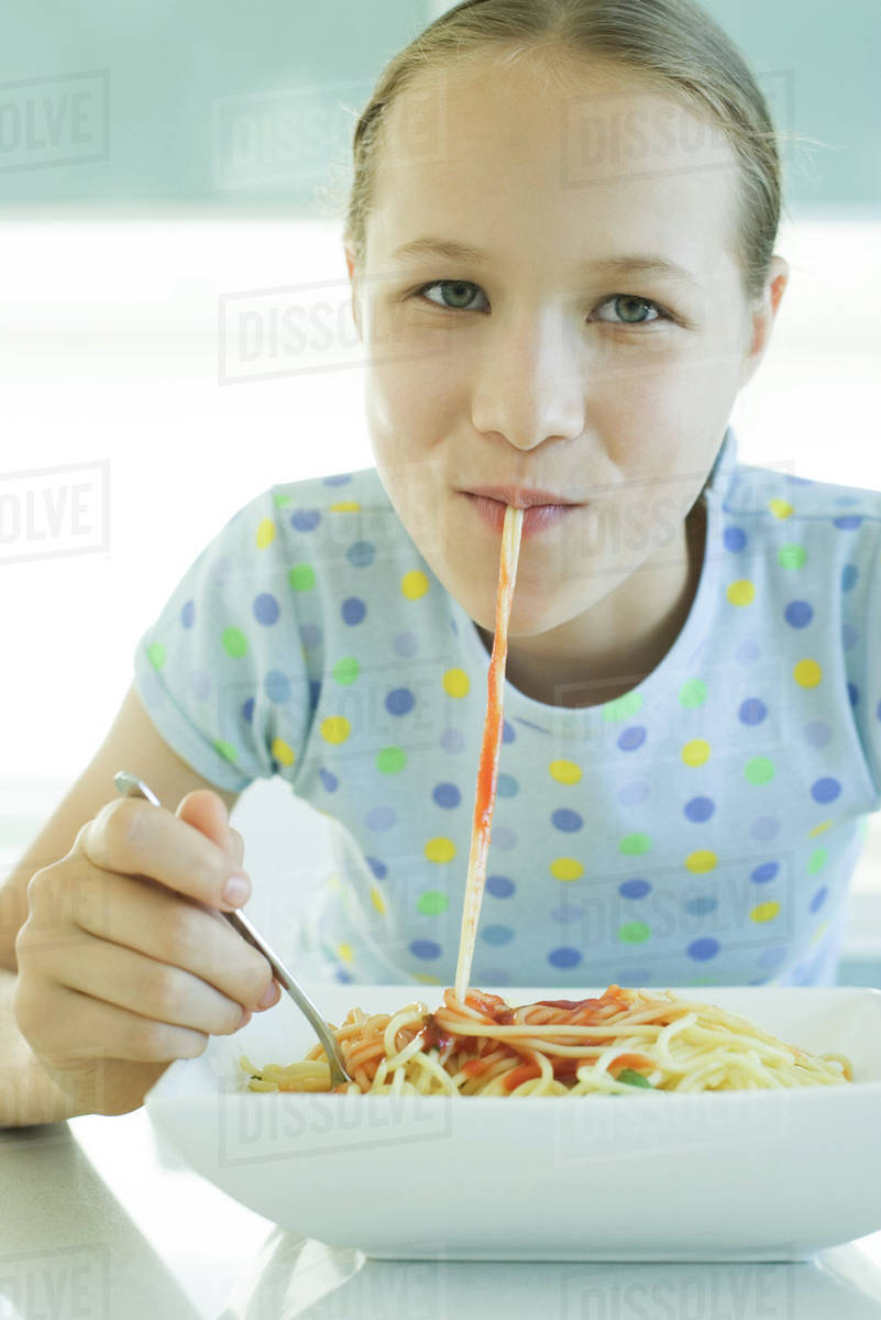 Girl slurping spaghetti noodles Stock Photo Dissolve