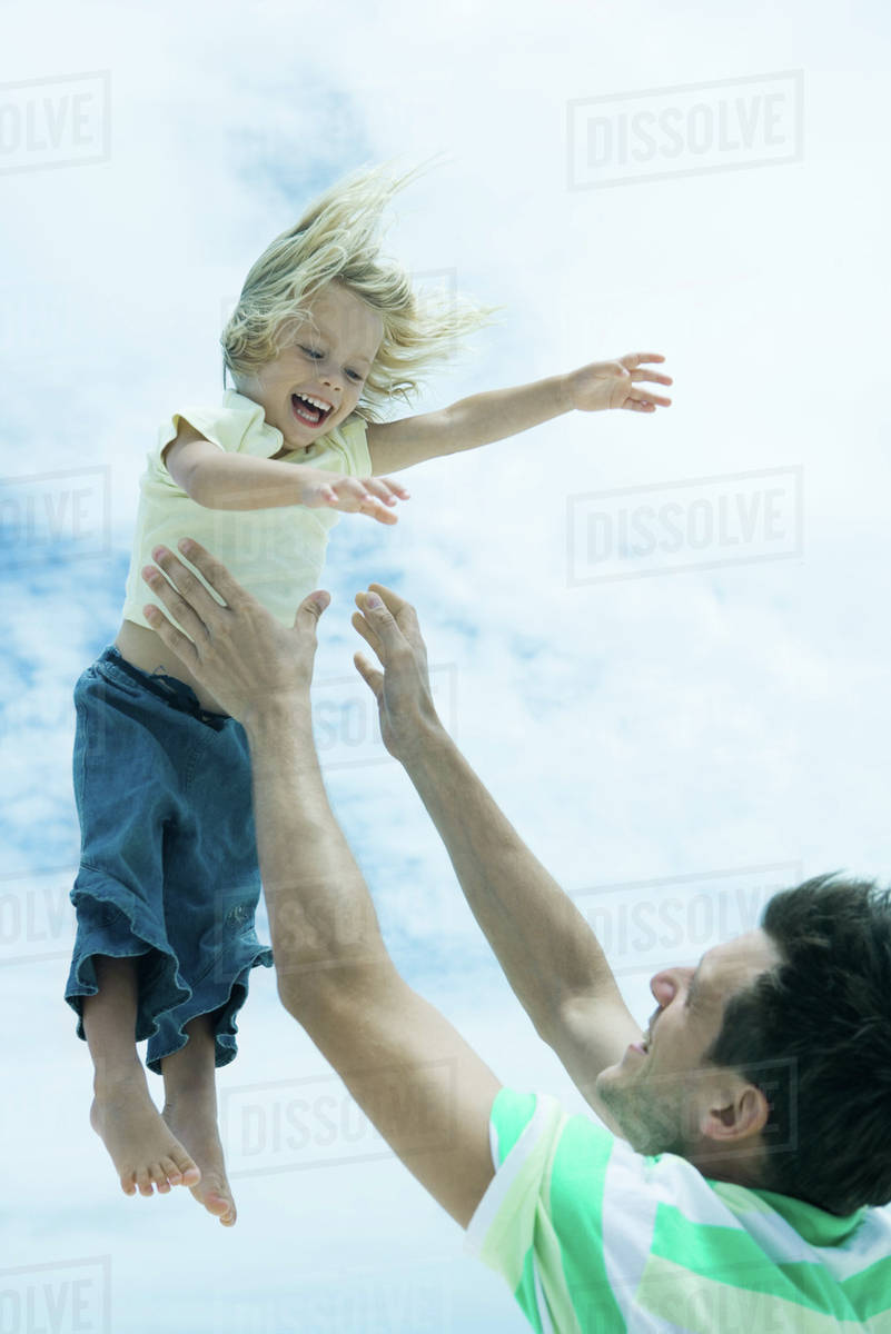 Man throwing child into air Stock Photo Dissolve