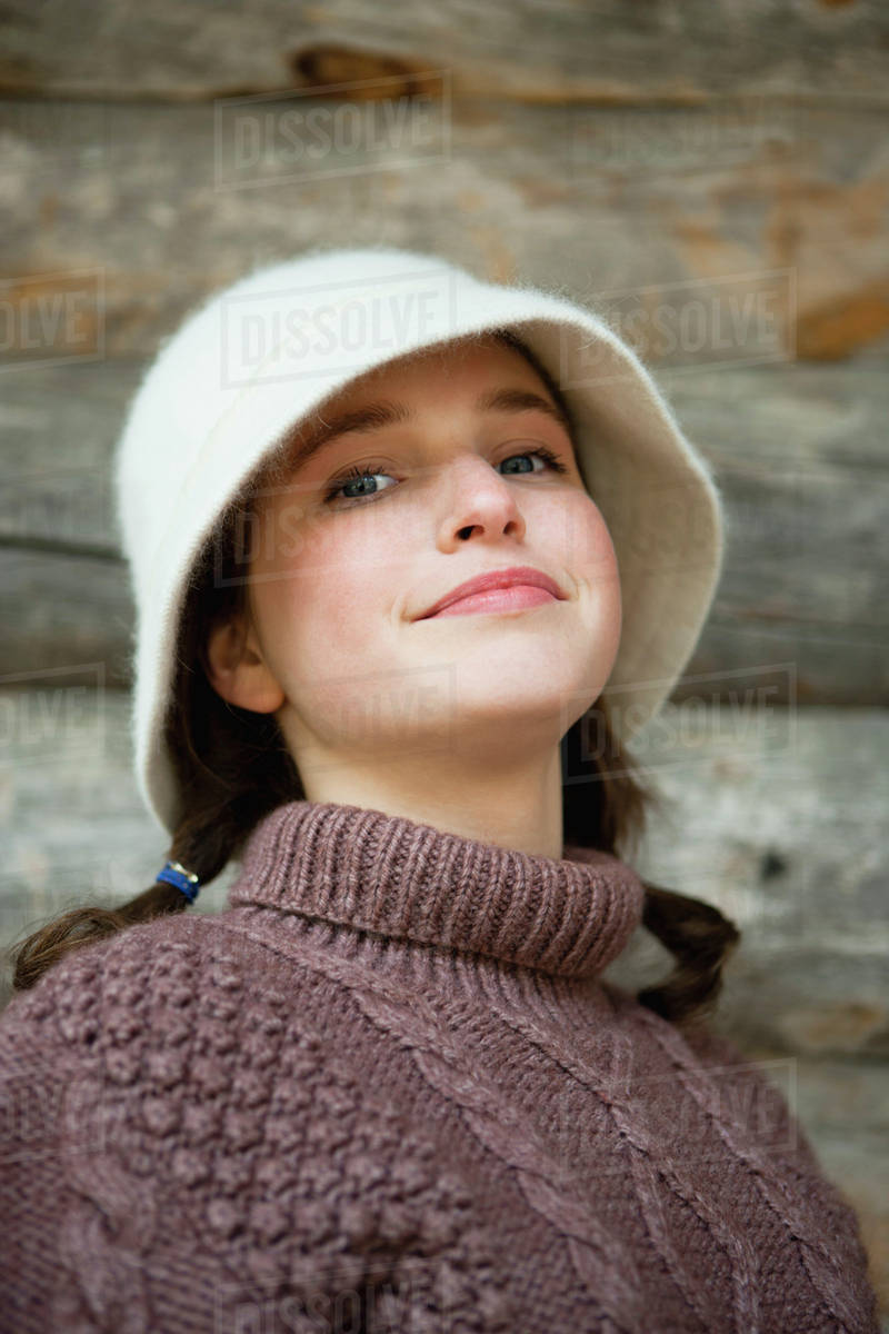 Teenage girl in turtleneck sweater, portrait Stock Photo Dissolve