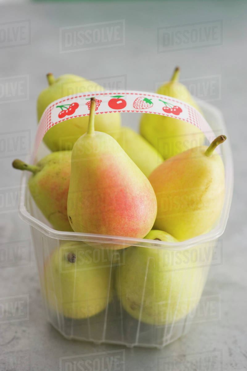 Pears in plastic container Stock Photo Dissolve
