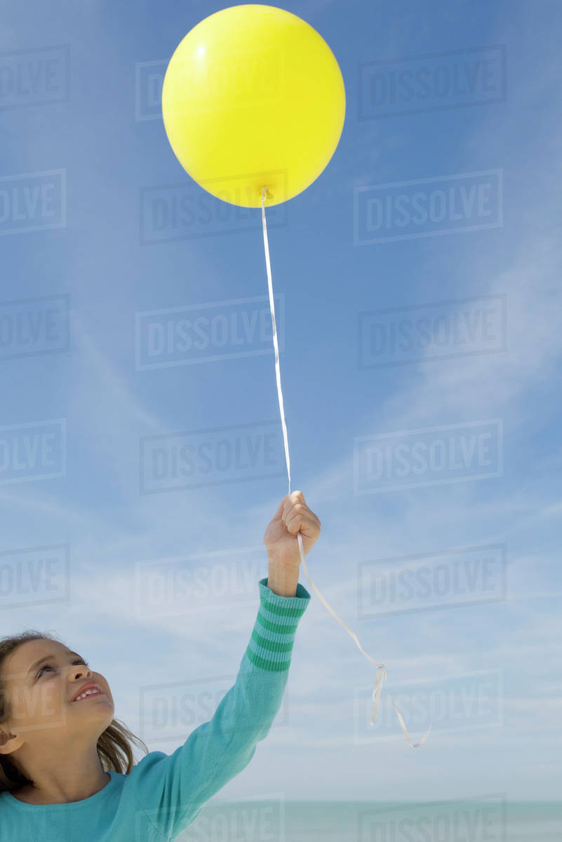 Girl holding balloon Stock Photo Dissolve