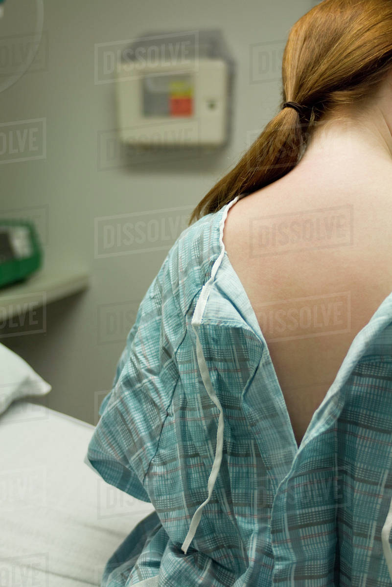 Female patient with examination gown open in back Stock Photo Dissolve
