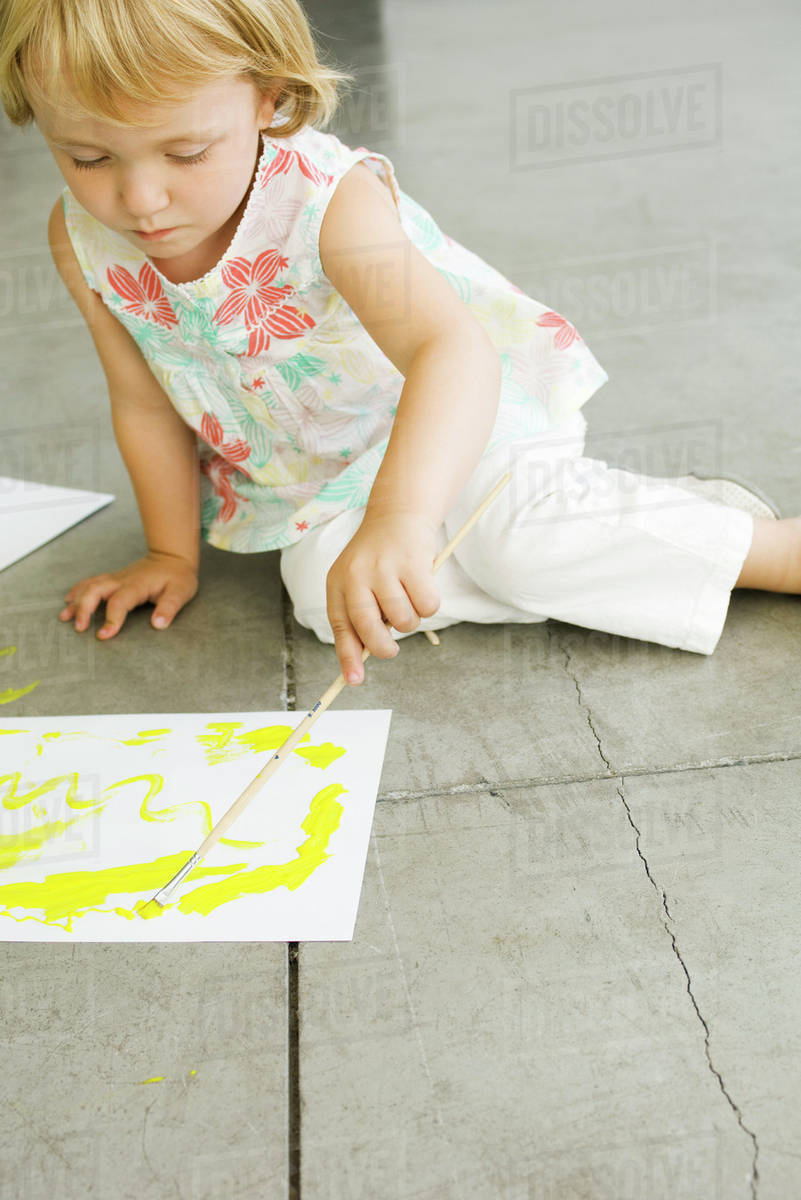 Little girl painting on paper - Royalty-free Stock Photo | Dissolve