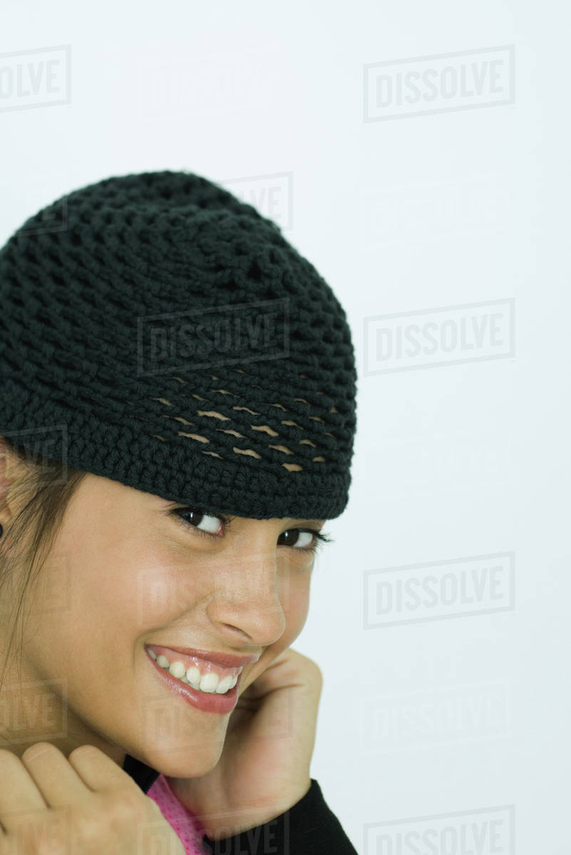 Teenage girl wearing knit hat, portrait Stock Photo Dissolve