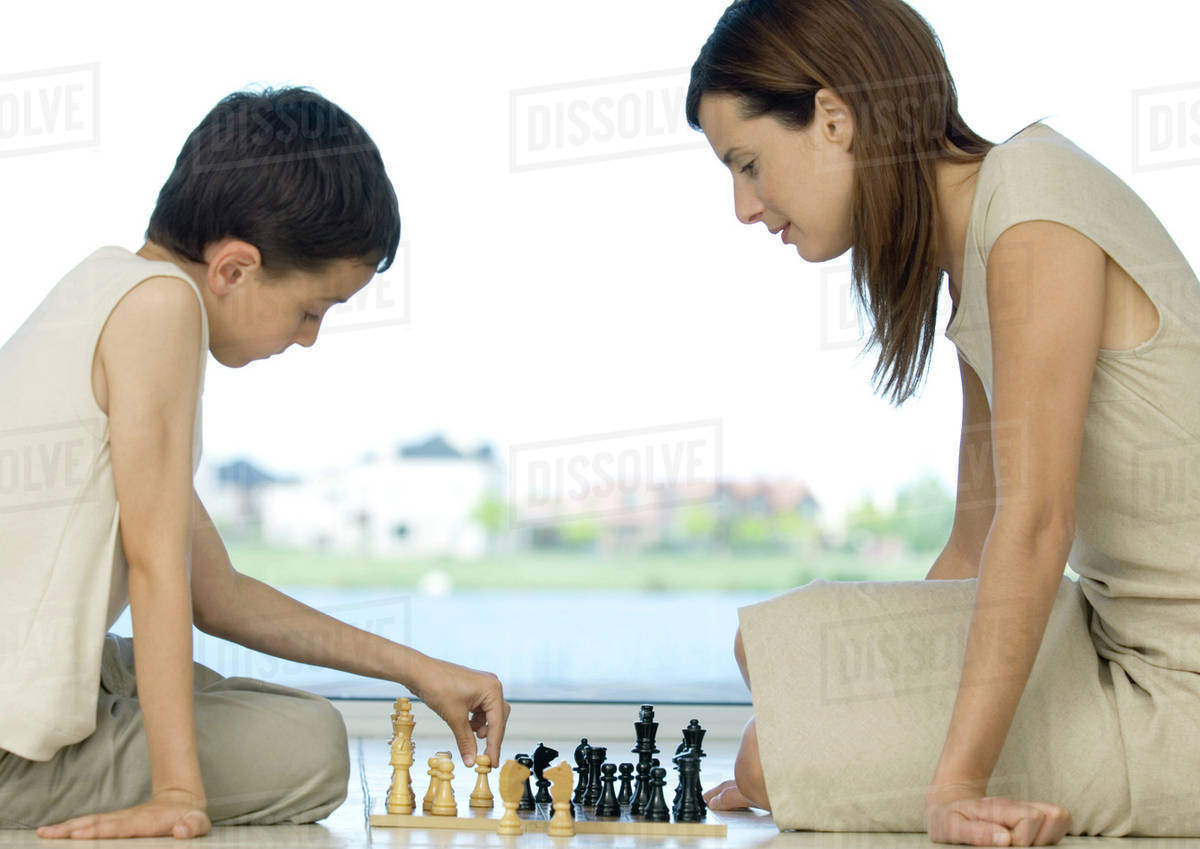 Mother and son playing chess Stock Photo Dissolve