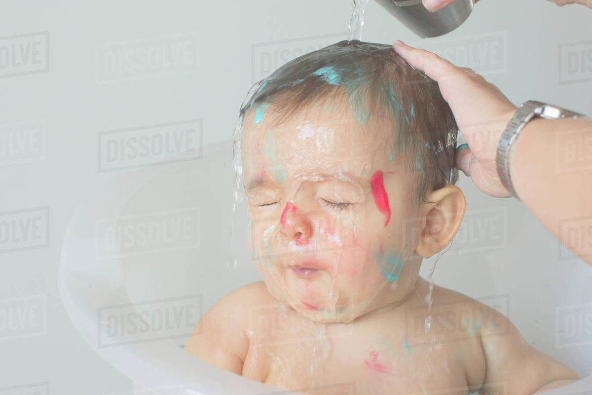 Baby being bathed Stock Photo Dissolve