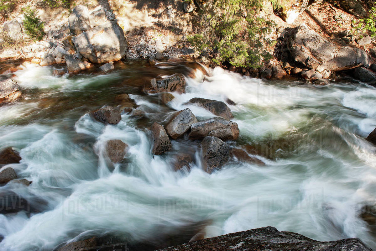 Stream flowing over rocks - Stock Photo - Dissolve