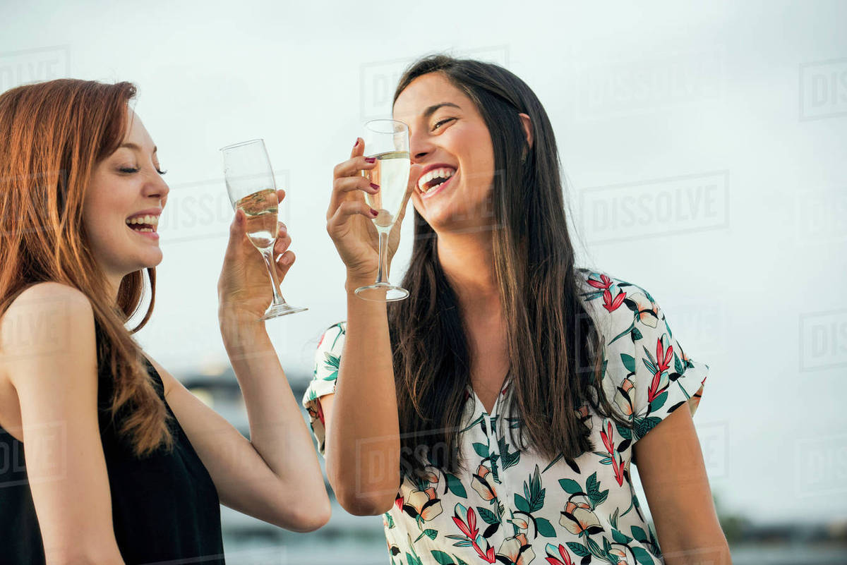 Women drinking champagne outdoors Stock Photo Dissolve