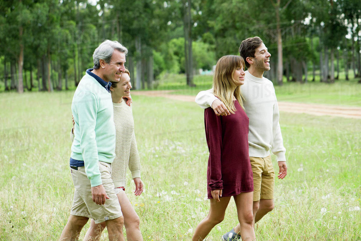 Couples walking together outdoors Stock Photo Dissolve