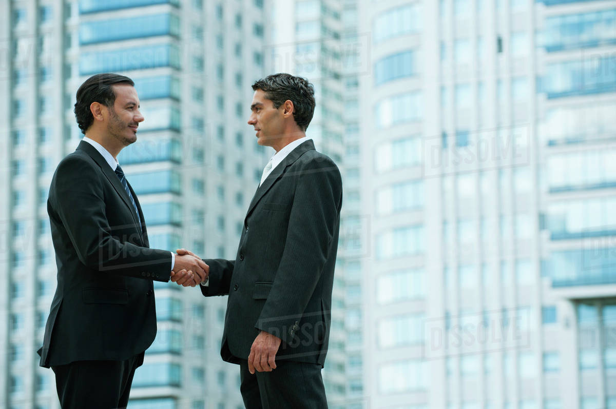 Business executives shaking hands Stock Photo Dissolve