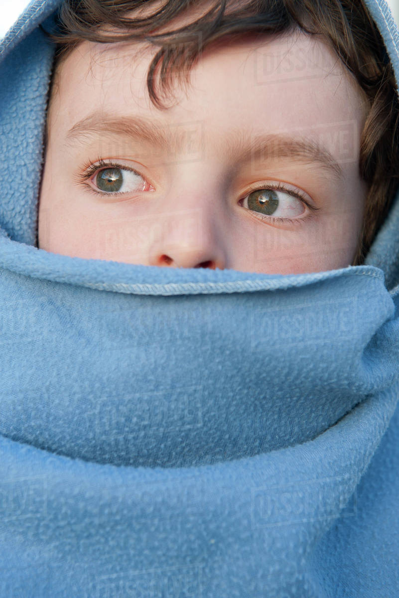 Boy wrapped up in blanket Stock Photo Dissolve