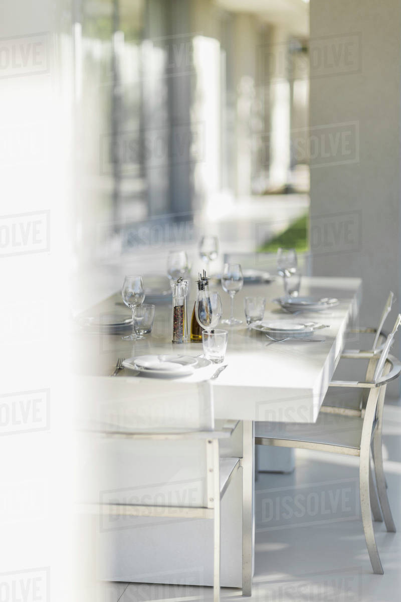 Set dining table on modern patio Stock Photo Dissolve