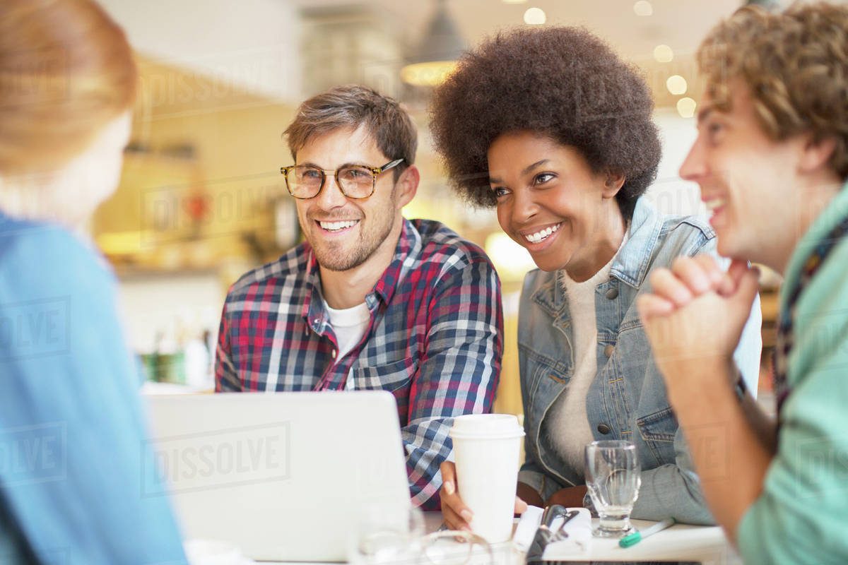 friends-drinking-coffee-together-in-cafe-stock-photo-dissolve