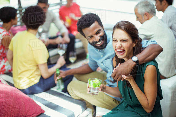 Couple hugging at party - Stock Photo - Dissolve