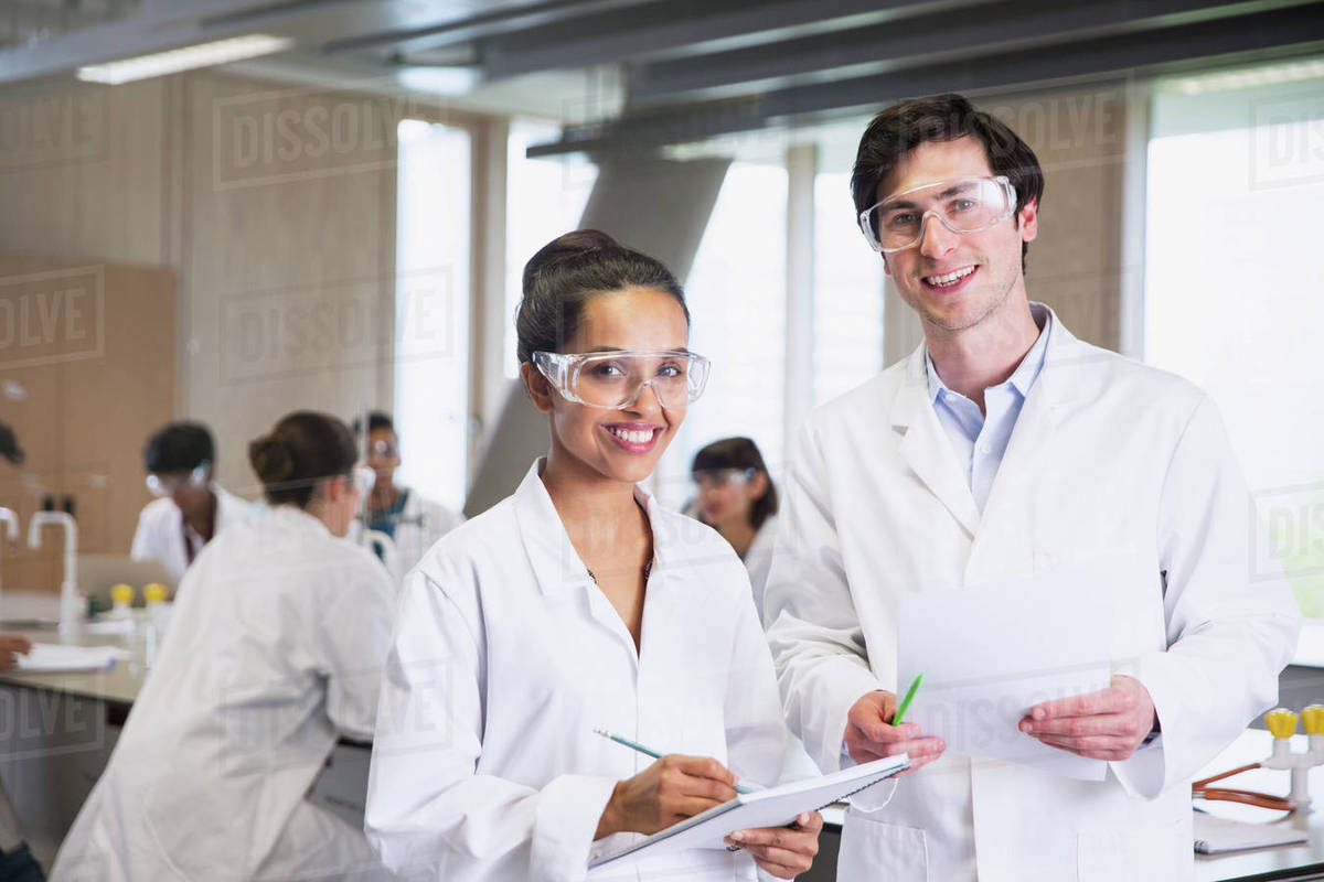 Portrait confident college students in lab coats in science laboratory classroom Royalty-free stock photo