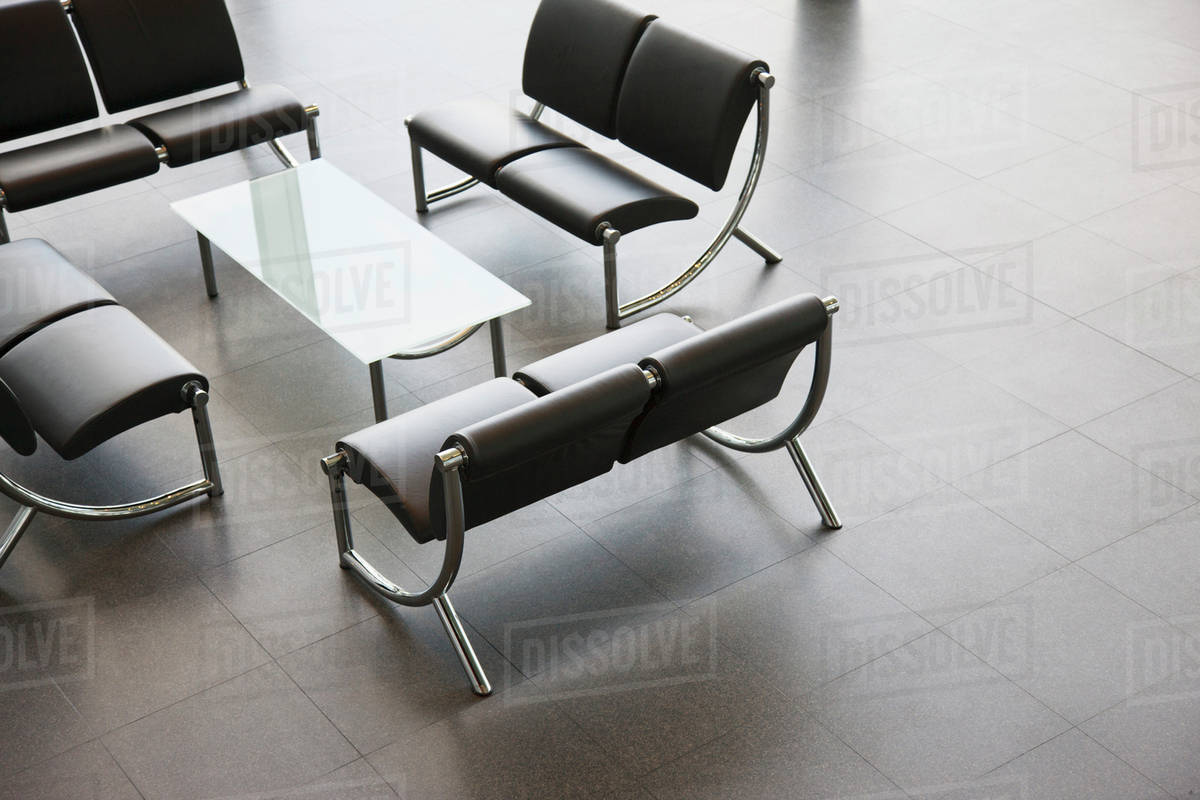 Chairs and table in office lobby area Stock Photo Dissolve