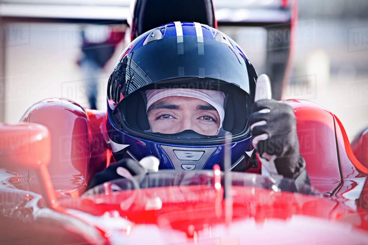 Portrait confident male formula one race car driver gesturing thumbs-up Royalty-free stock photo