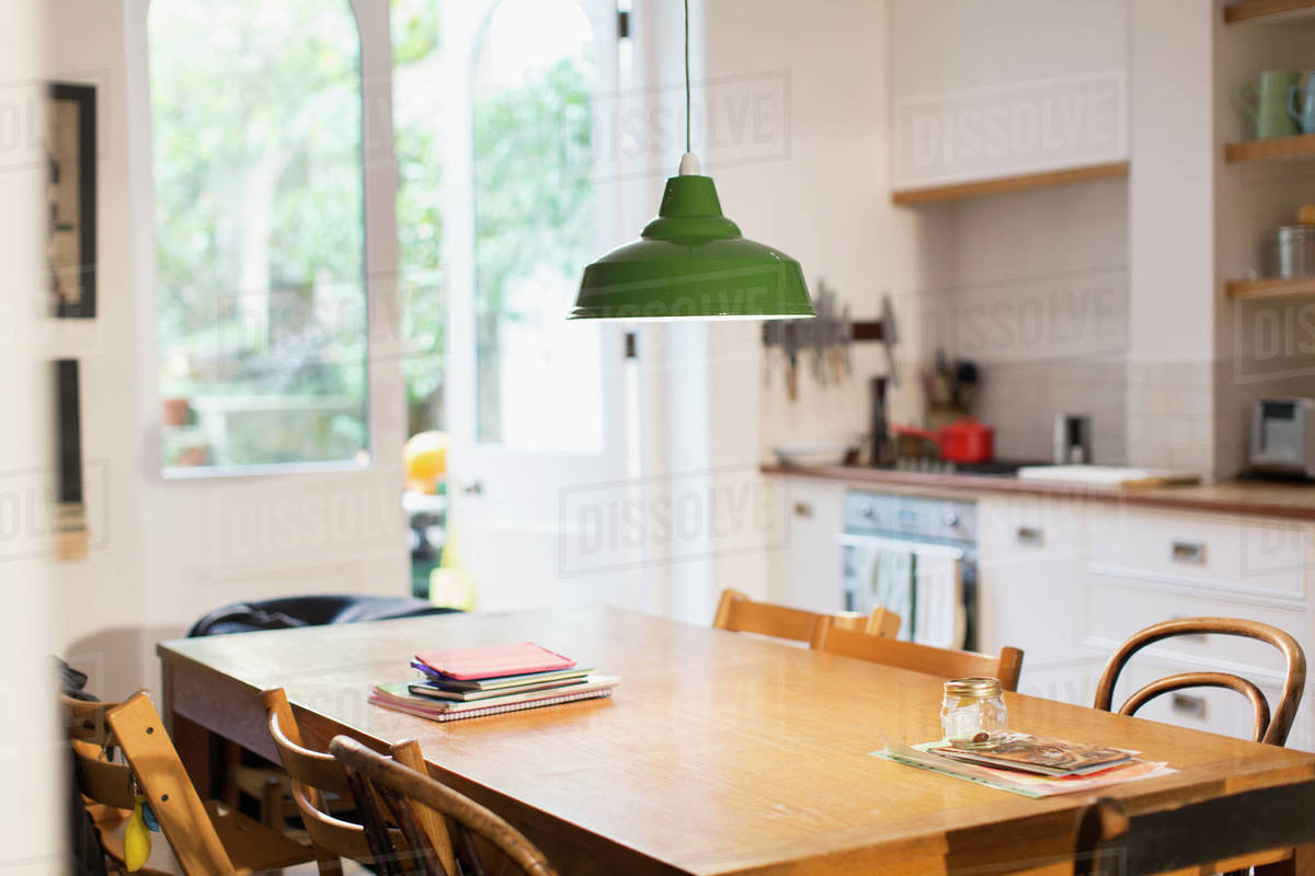 Green Pendant Light Hanging Over Dining Table Stock Photo Dissolve Green Pendant Light Hanging Over Dining, What Size Pendant For Dining Table