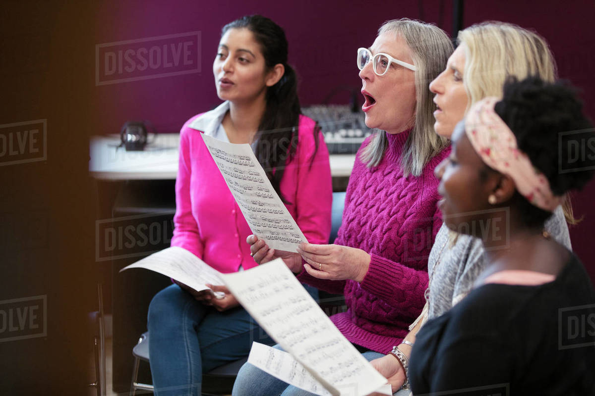 Womens choir with sheet music singing in music recording studio Royalty-free stock photo