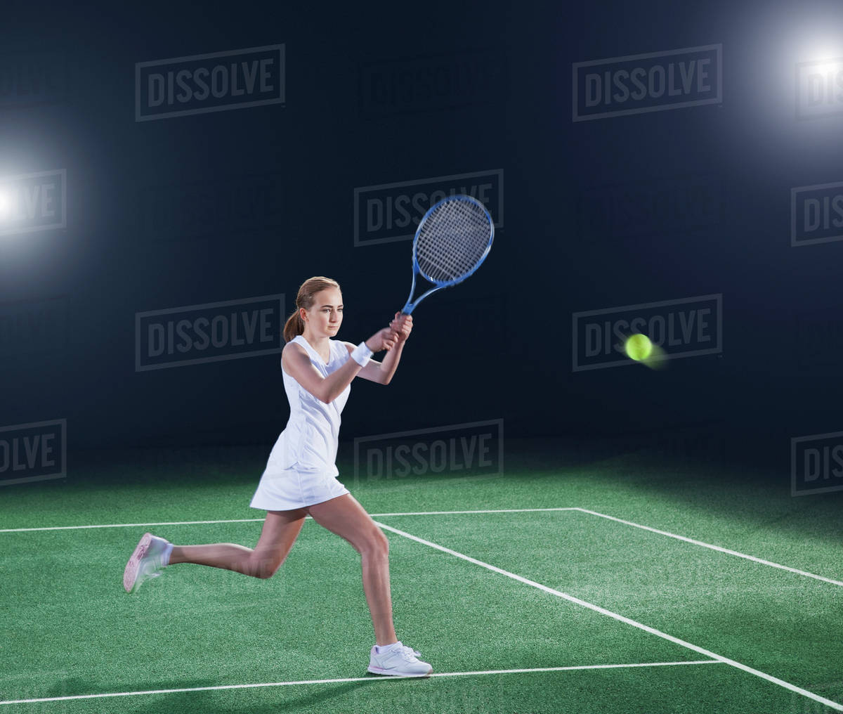 Tennis player hitting ball on court Stock Photo Dissolve