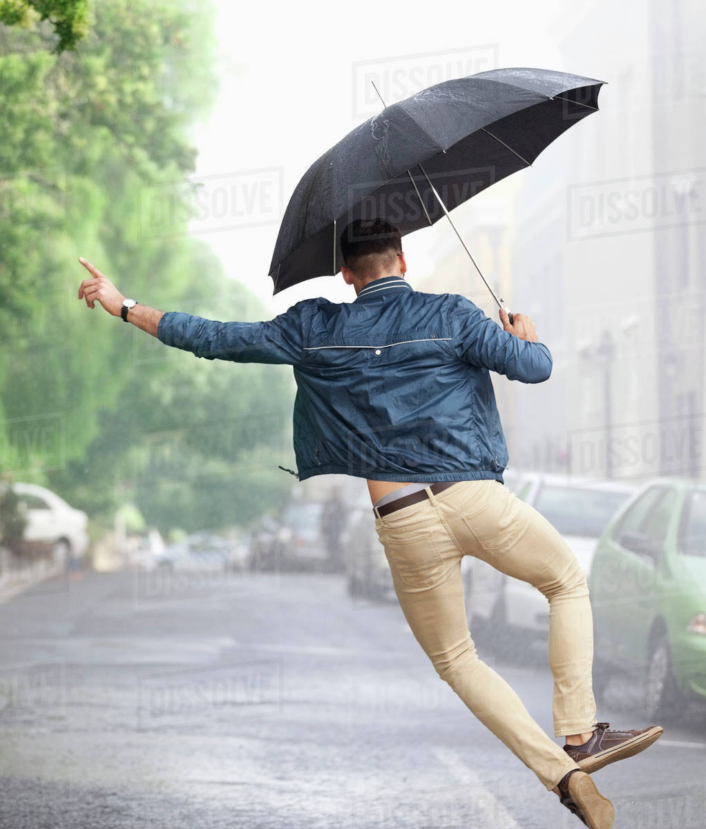 man dancing with umbrella