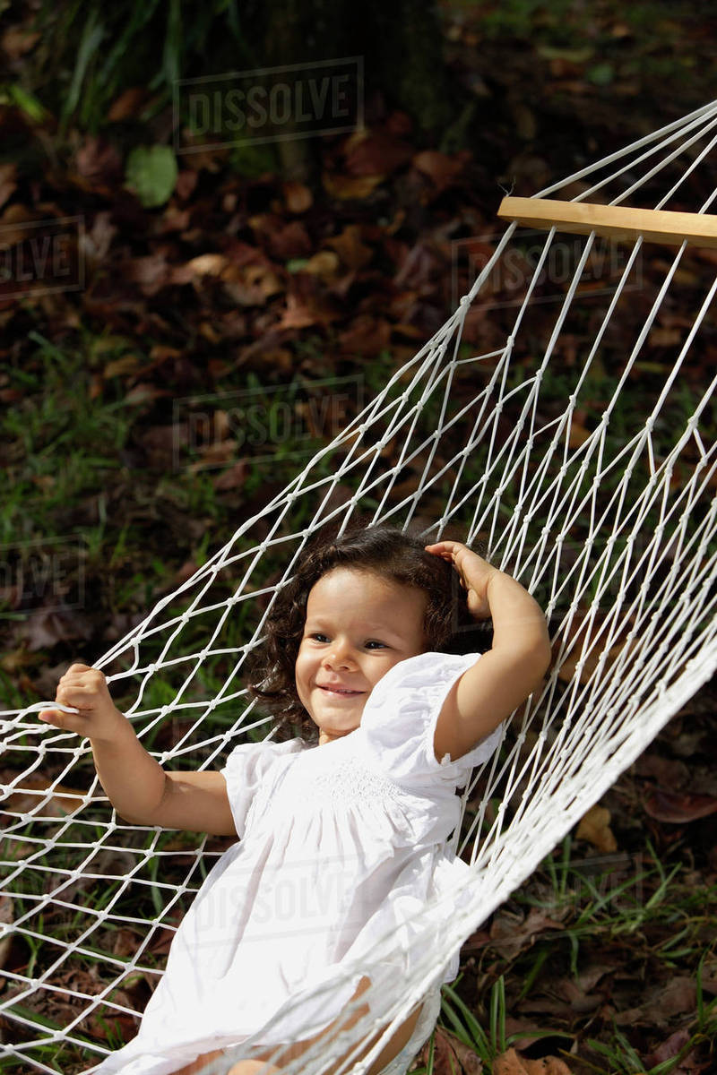 Girl swinging in hammock Stock Photo Dissolve