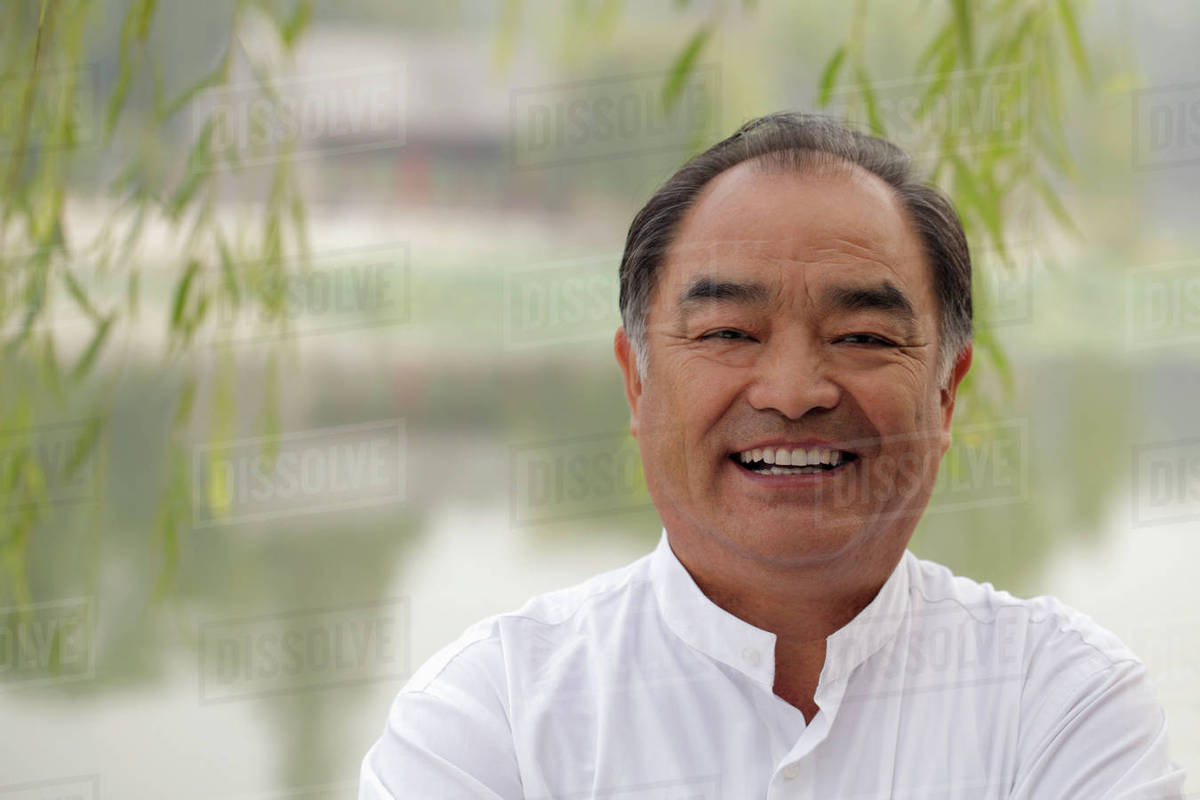 Head shot of older man smiling at camera, outdoors Royalty-free stock photo