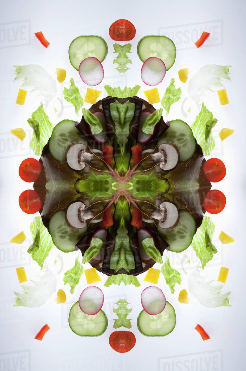 A digital composite of mirrored images of pieces of a mixed vegetable
