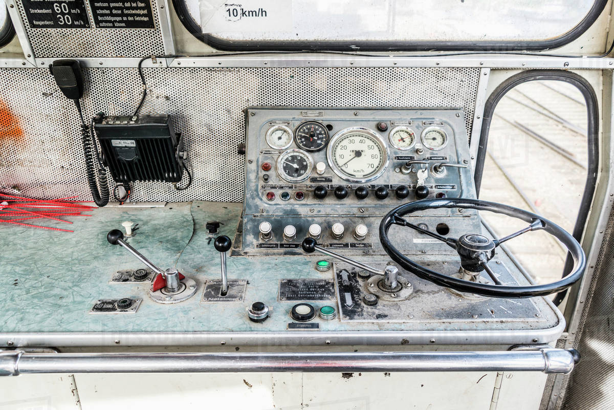 Steering wheel and control panel in train Stock Photo Dissolve